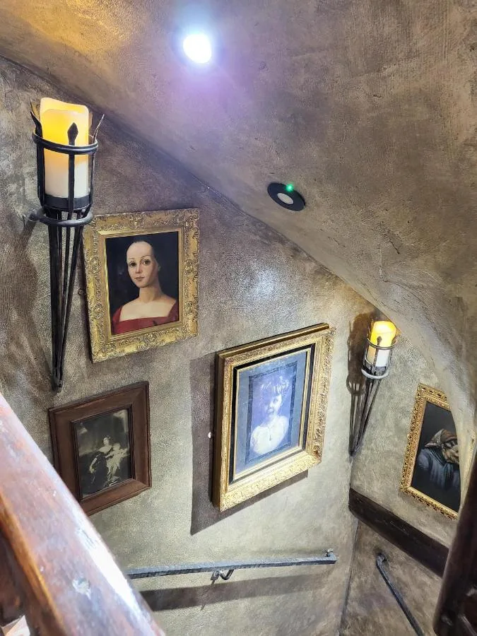 A group of framed pictures on a wall at Hocus Pocus Tiny Hotel, York